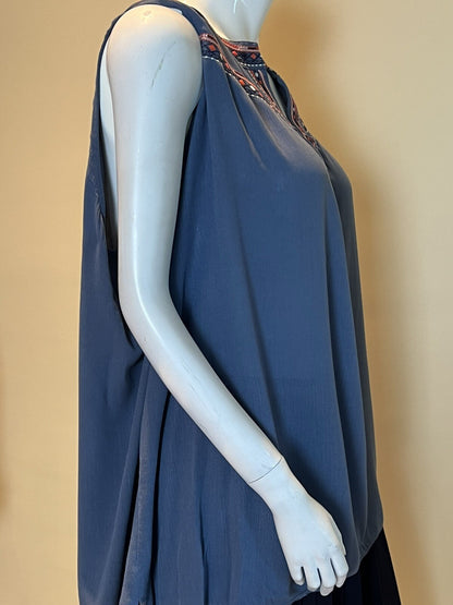 Side view of Whispers blue sleeveless top