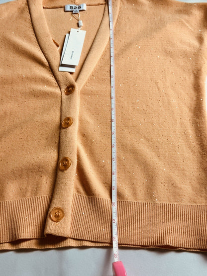 525 America Melon cardigan laid flat with vertical measurement tape