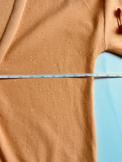 525 America cardigan laid flat with horizontal measurement tape