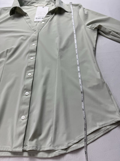 Luxe blouse laid flat with vertical measuring tape