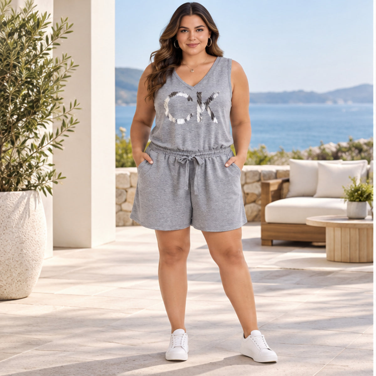 Calvin Klein women's gray 1X sequin logo romper front model view
